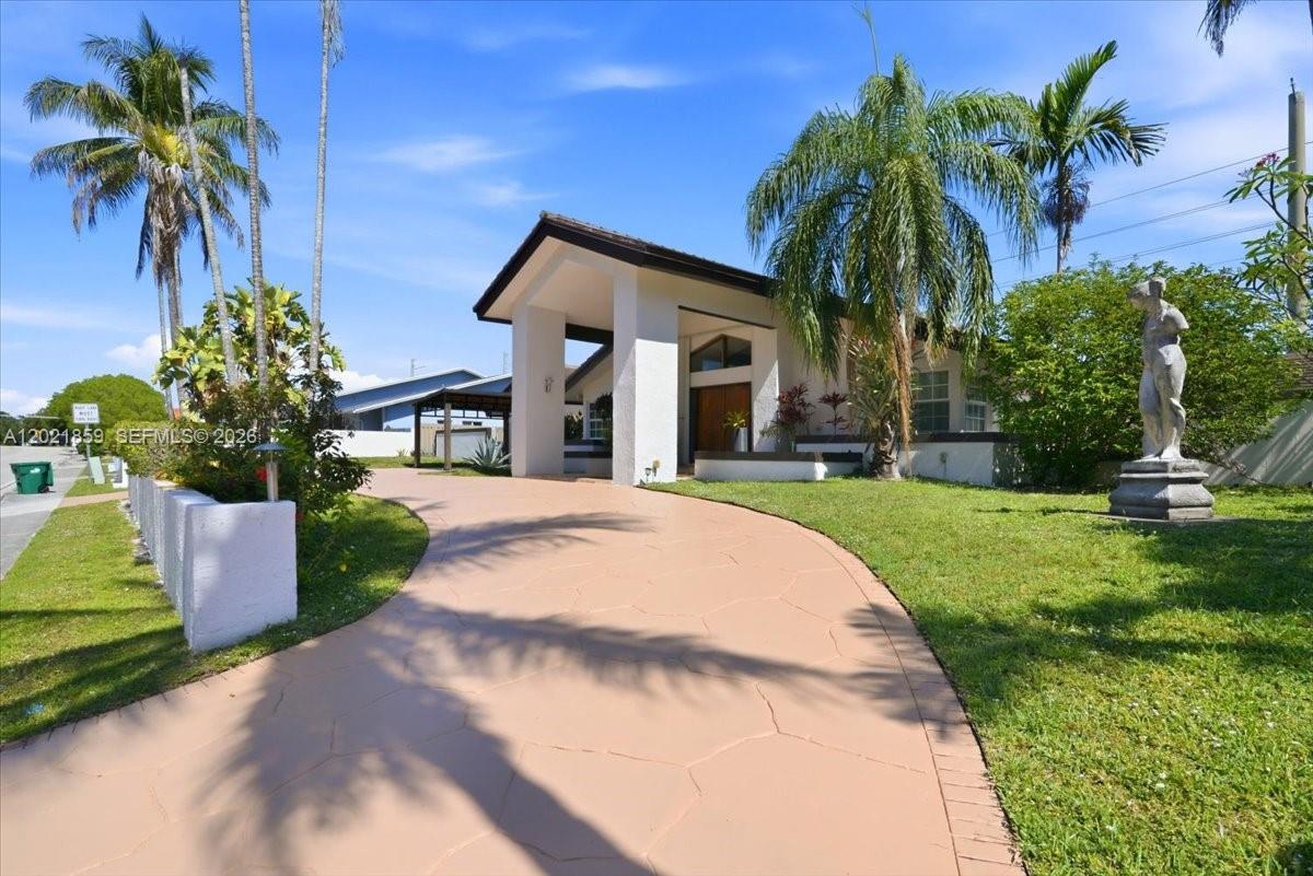 A curved driveway leads to the entrance of a house with a palm tree — 9665 SW 136th St, Miami FL 33176, MIAMI, FL