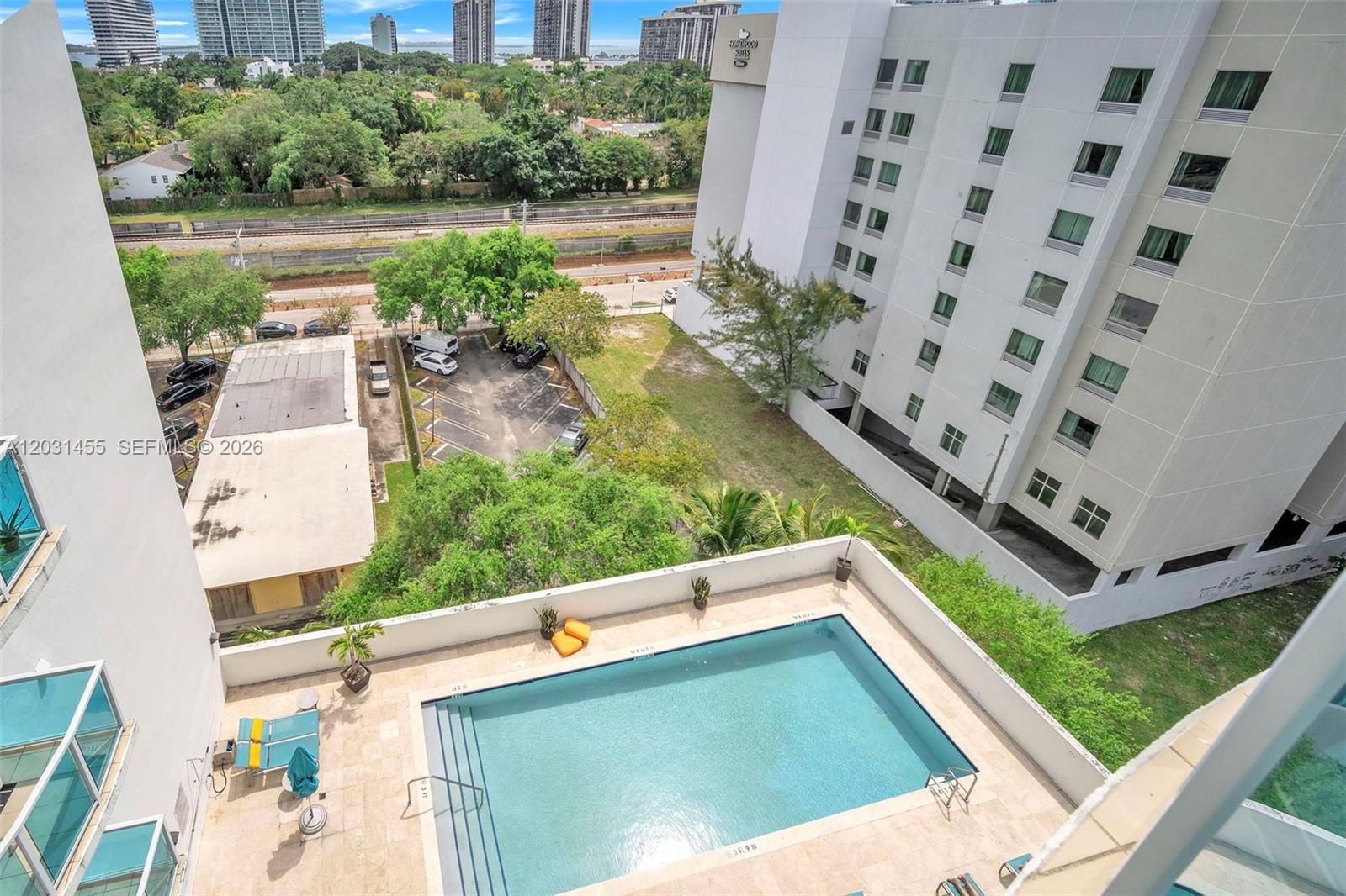 An elevated view shows a rectangular swimming pool on a terrace next to a hotel — 1723 SW 2nd Ave # 1001, Miami FL 33129, MIAMI, FL