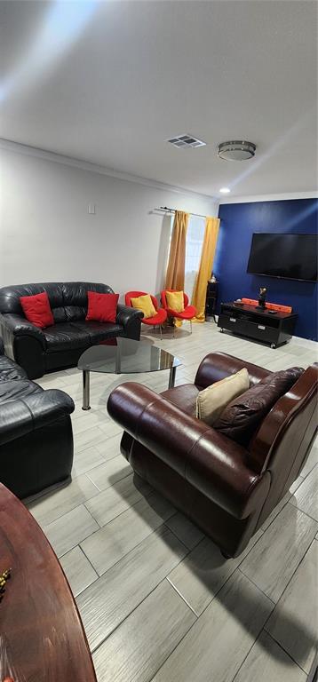 A living room features black leather sofas, a brown leather armchair, and yellow curtains — 4306 W LA SALLE STREET, TAMPA, FL