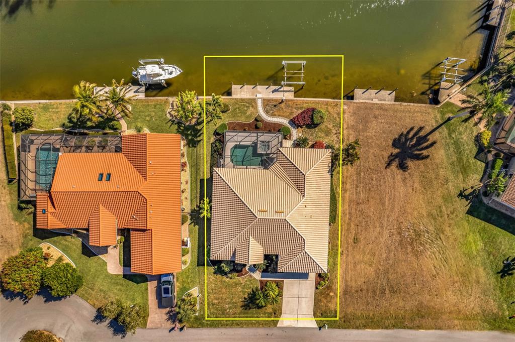 An aerial view shows a waterfront house with a pool, dock, and paved driveway — 3518 TERIN COURT, PUNTA GORDA, FL