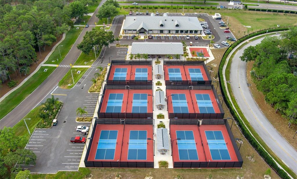 An aerial view shows a community center with multiple pickleball courts and a parking lot — 6409 WEDGEWOOD DRIVE, SPRING HILL, FL