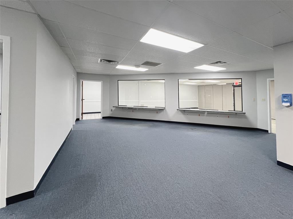 An office space features blue carpeting, white walls, drop ceilings, and two large service windows — 500 W LAKE MARY BOULEVARD UNIT 536, SANFORD, FL