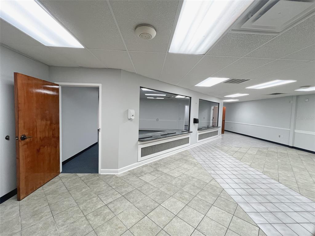 An office interior features a tiled floor, a wooden door, and glass service windows — 500 W LAKE MARY BOULEVARD UNIT 536, SANFORD, FL