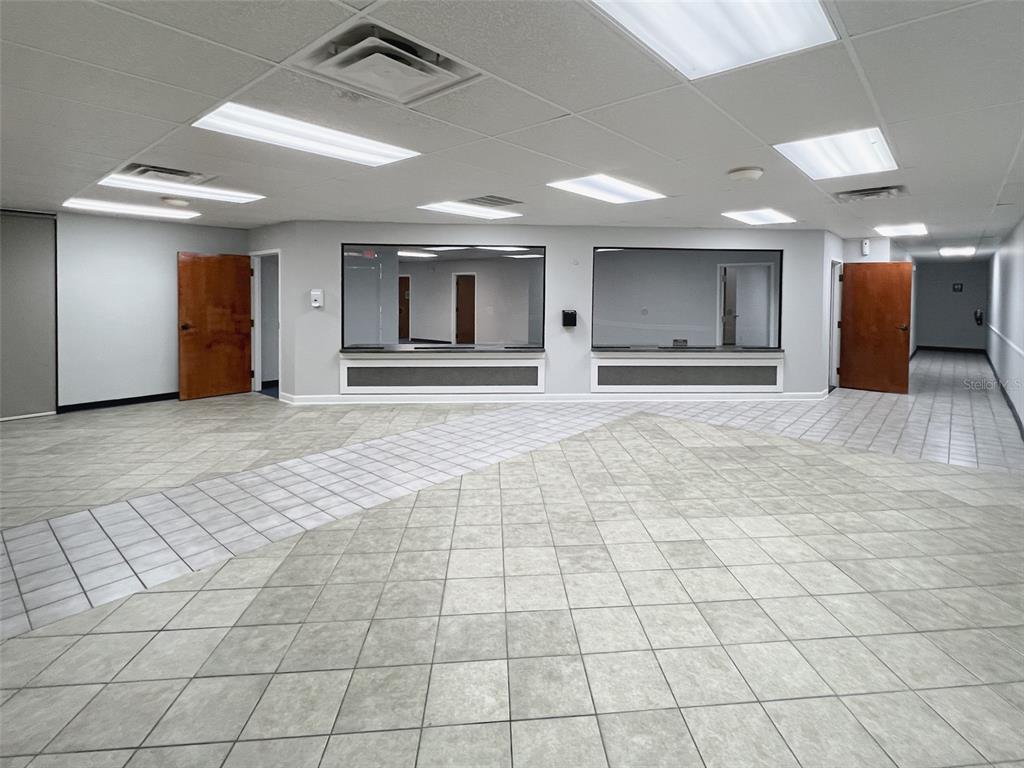 An empty commercial office space features tiled floors, two service windows, and wooden doors — 500 W LAKE MARY BOULEVARD UNIT 536, SANFORD, FL