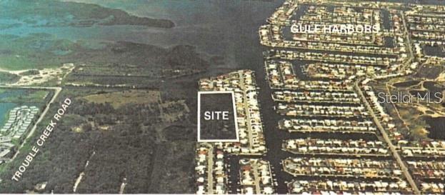 An aerial map shows a vacant rectangular lot labeled site located near a residential canal community — 4218 RUDDER WAY, NEW PORT RICHEY, FL