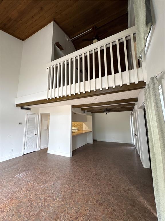 A living area features a high wood-paneled ceiling, a loft balcony, and cork flooring — 2010 CORNER LAKE DRIVE UNIT 2010, HAINES CITY, FL