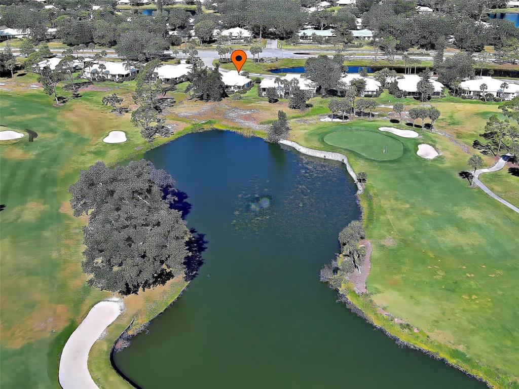 An aerial view shows a house marked with a pin overlooking a golf course pond — 262 CERROMAR WAY S UNIT 53, VENICE, FL