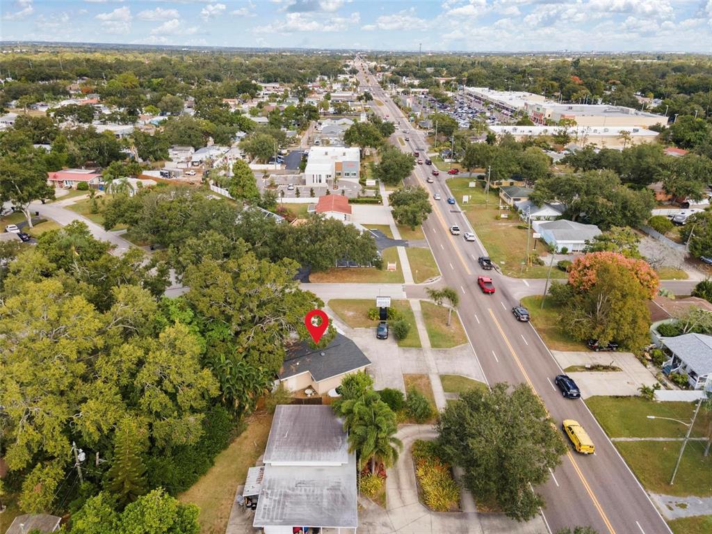 An aerial view shows a house with a red location pin near a busy road — 4900 33RD AVENUE N, ST PETERSBURG, FL
