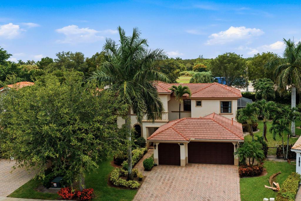 A two-story house with a tile roof, a two-car garage, and a paved driveway — 8105 Ferentino Pass, Delray Beach FL 33446, DELRAY BEACH, FL