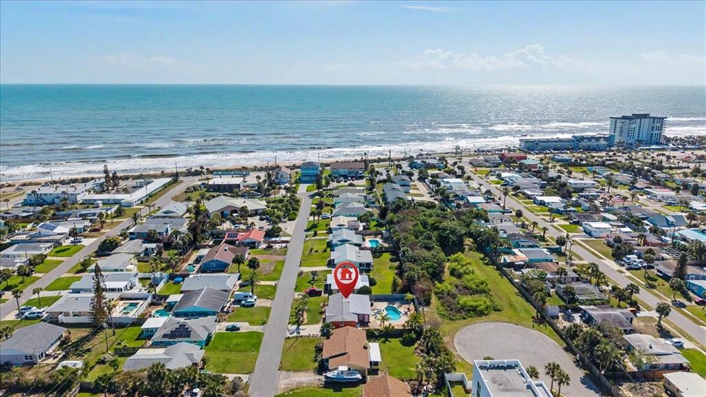An aerial view shows a coastal neighborhood with a red house marker on a property — 18 CONCORD DRIVE, ORMOND BEACH, FL