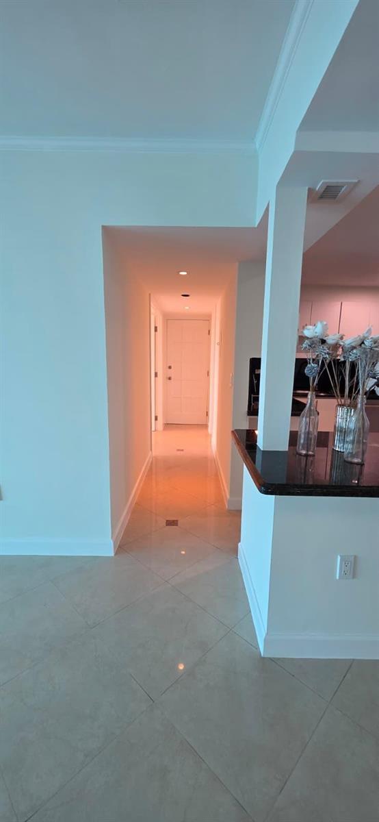 A spacious lobby features a coffered ceiling, wood paneling, and a checkered marble floor — 11111 Biscayne Boulevard # 4c, Miami FL 33181, MIAMI, FL