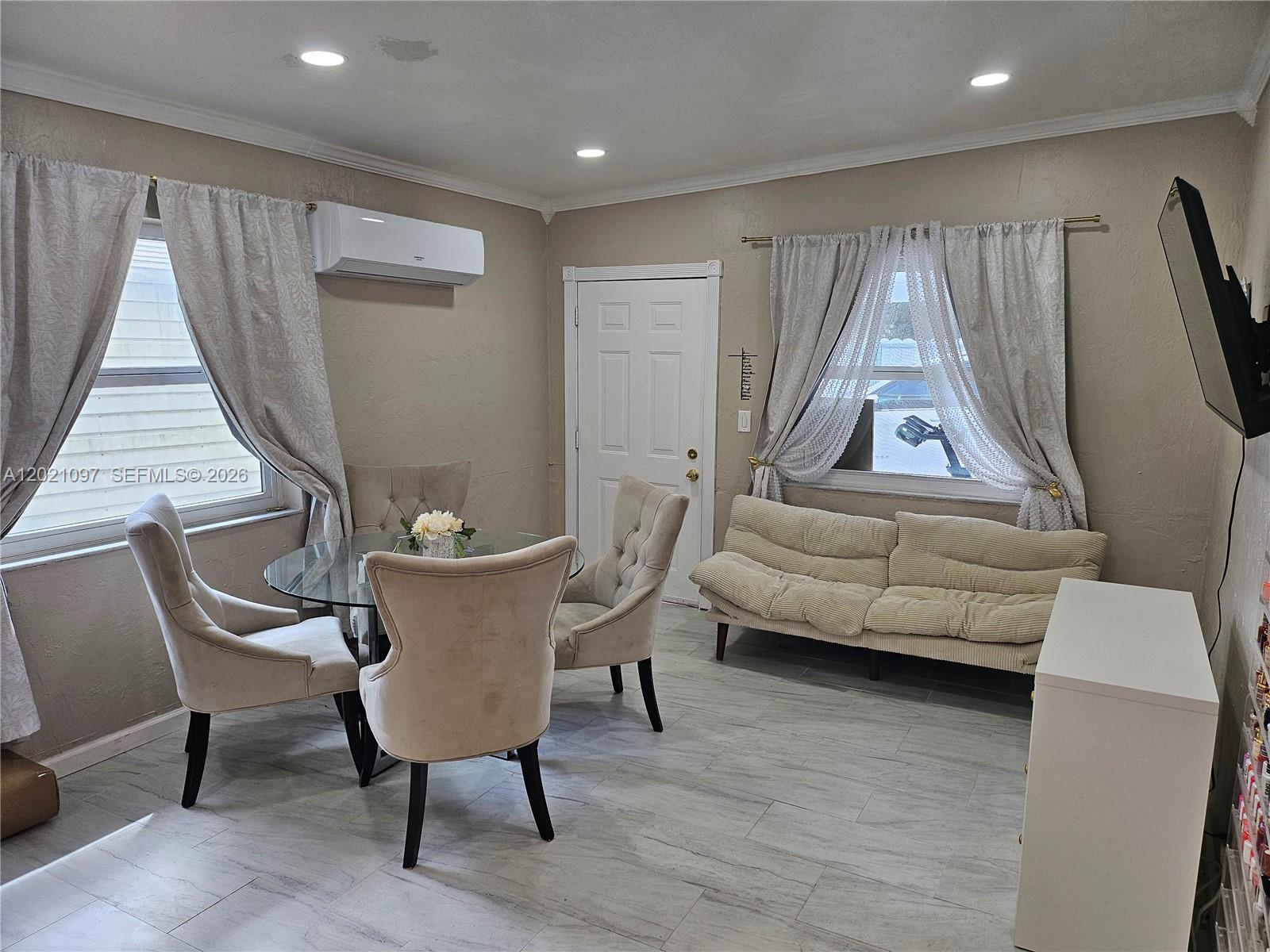 A dining area features a glass table, four upholstered chairs, a sofa, and tile flooring — 528 NW 10th St, Florida City FL 33034, FLORIDA CITY, FL