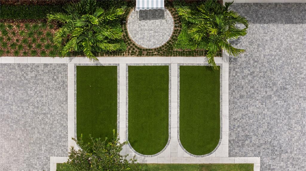 An aerial view shows three rectangular artificial turf patches bordered by stone pavers and landscaping — 1836 WHITEHALL DRIVE, WINTER PARK, FL