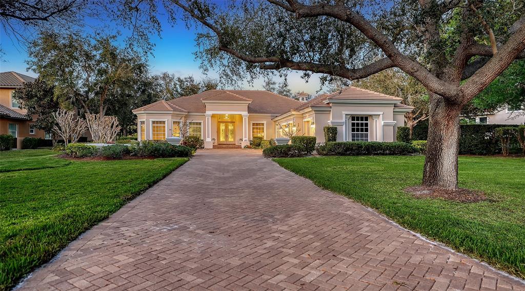 A single-story house with a brick driveway and a large tree in the front yard — 480 ORISKANY COURT, OSPREY, FL