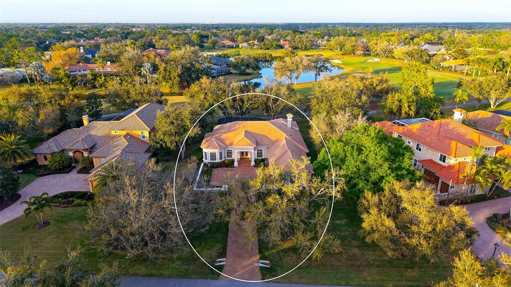 An aerial view shows a single-story house with a tile roof and a brick driveway — 480 ORISKANY COURT, OSPREY, FL