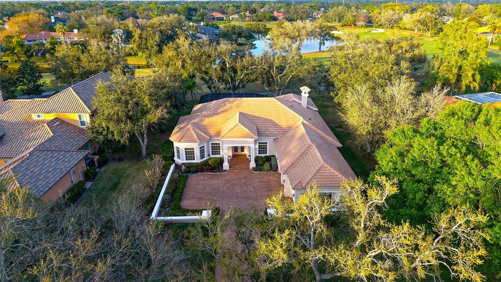 An aerial view of a single-story house with a tiled roof and brick driveway — 480 ORISKANY COURT, OSPREY, FL