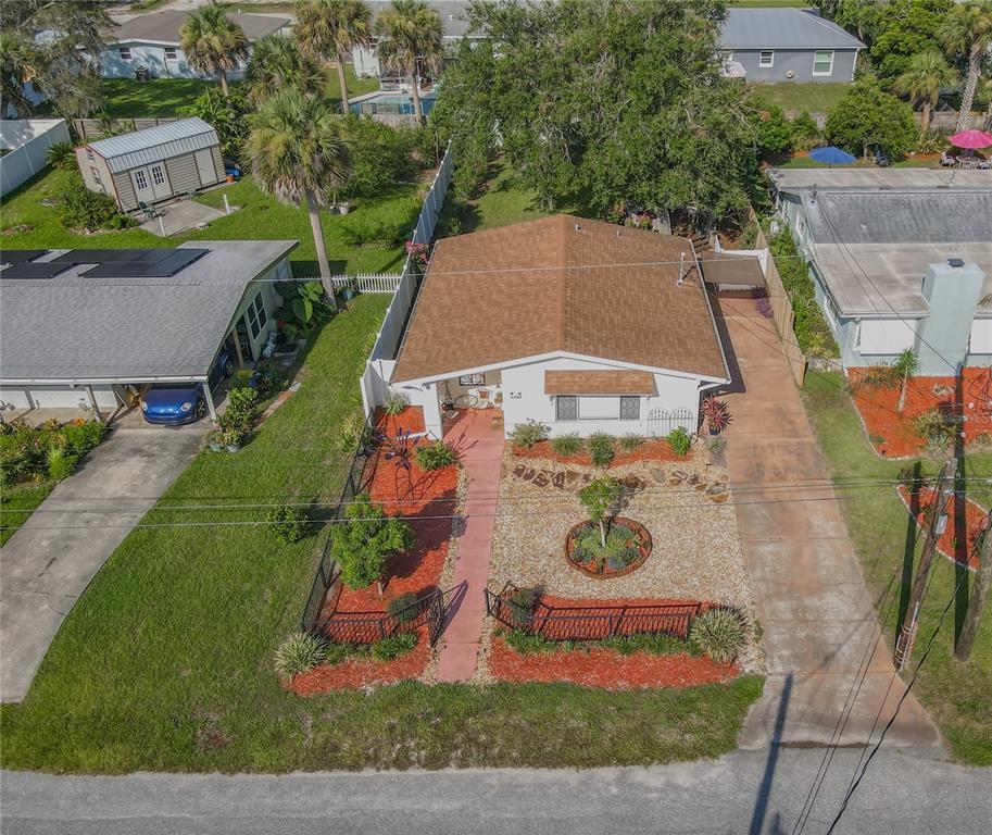 An aerial view of a single-story house with a brown roof and a landscaped yard — 906 FERNALD STREET, EDGEWATER, FL