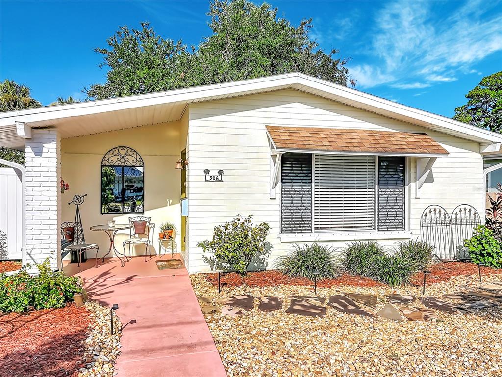 A single-story house with white siding, a red walkway, and a front porch area — 906 FERNALD STREET, EDGEWATER, FL