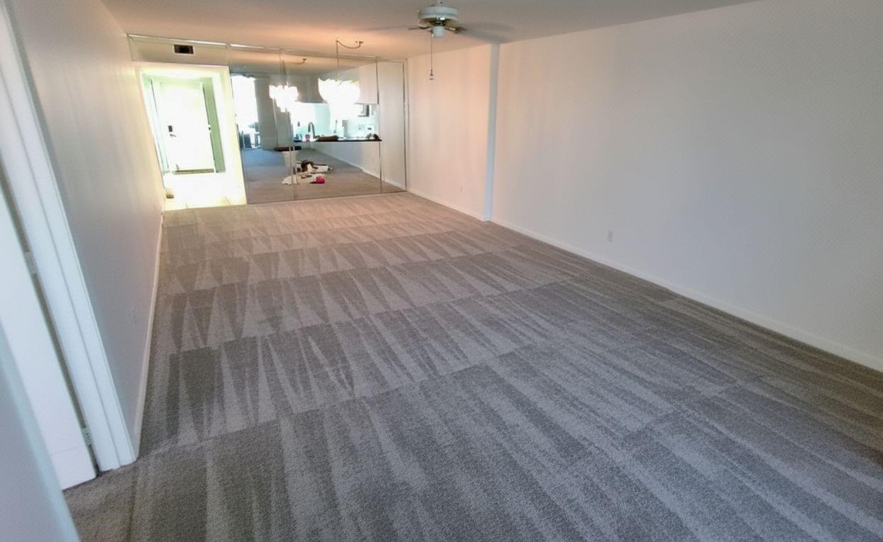 An empty room features gray patterned carpeting, white walls, and a wall of mirrored closet doors — 4735 E Lucerne Lakes Boulevard E # 413, Lake Worth FL 33467, LAKE WORTH, FL