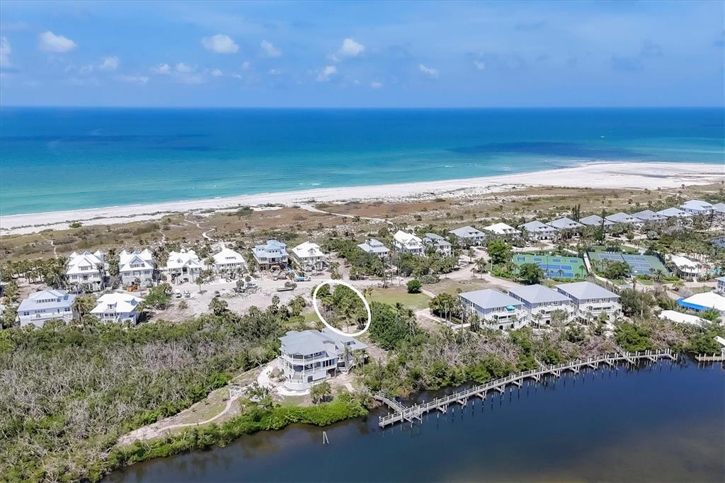An aerial view shows a coastal neighborhood with a circled vacant lot near a house — 7365 PALM ISLAND DRIVE, PLACIDA, FL