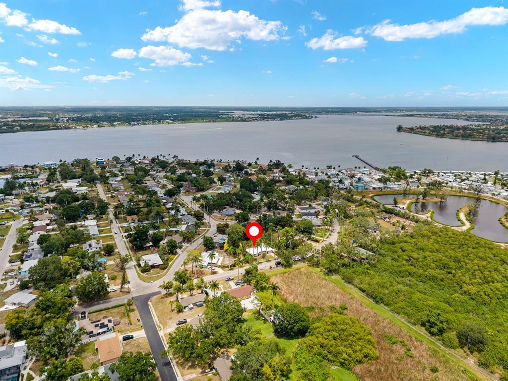An aerial view shows a residential neighborhood near a large body of water — 2415 2ND AVENUE E, BRADENTON, FL
