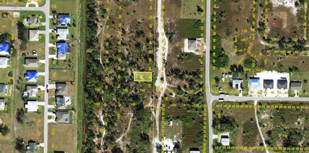 An aerial map view shows a vacant rectangular lot highlighted in yellow amidst undeveloped land — 2397 HIGHLANDS ROAD, PUNTA GORDA, FL