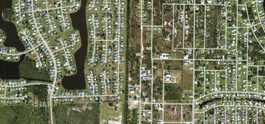 This is an aerial map view of a residential neighborhood with streets and undeveloped land — 2397 HIGHLANDS ROAD, PUNTA GORDA, FL