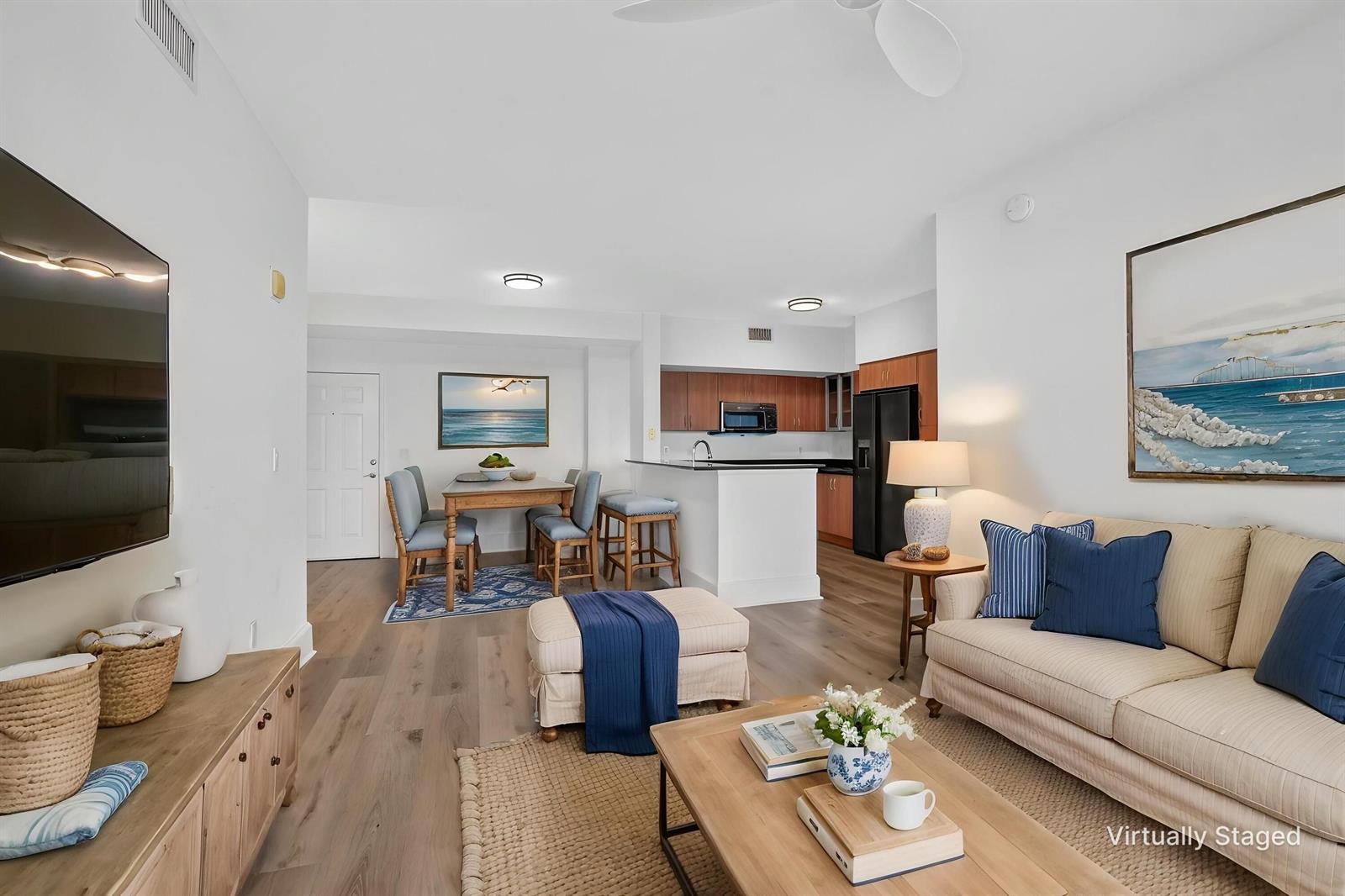 A living room and dining area with light wood floors and a kitchen with cabinets — 233 S Federal Highway # 623, Boca Raton FL 33432, BOCA RATON, FL