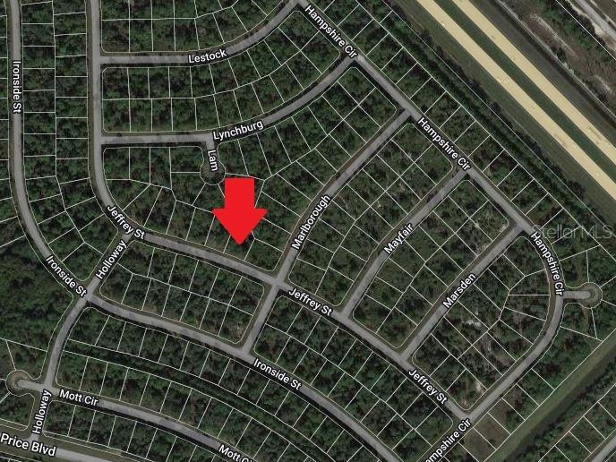 This is an aerial map showing a vacant residential lot marked with a red arrow — LOT 26 JULIANNA STREET, NORTH PORT, FL