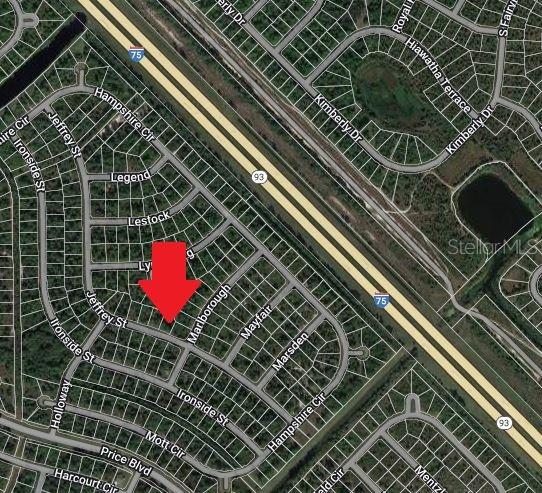 This is a satellite map view showing a residential neighborhood with a red arrow pointing down — LOT 26 JULIANNA STREET, NORTH PORT, FL
