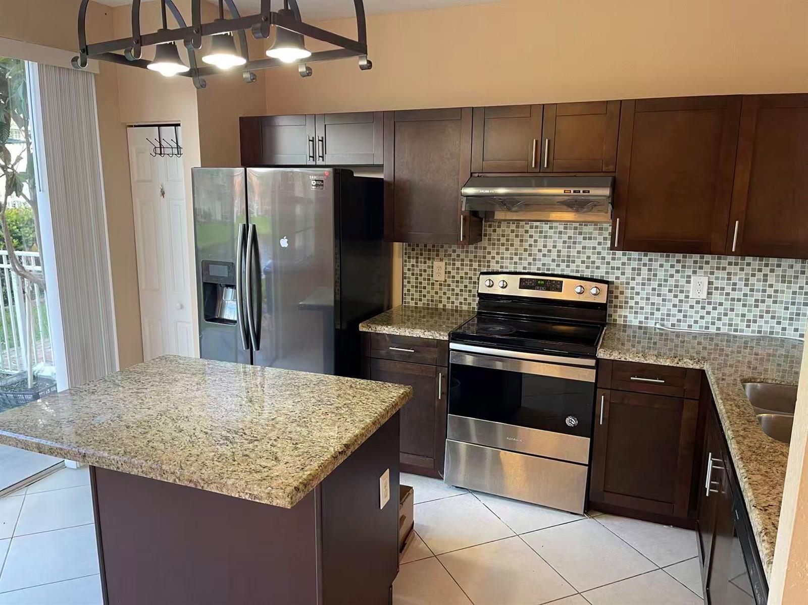 A kitchen features dark wood cabinets, granite countertops, stainless steel appliances, and a tiled backsplash — 4061 NW 91st Terrace, Sunrise FL 33351, SUNRISE, FL