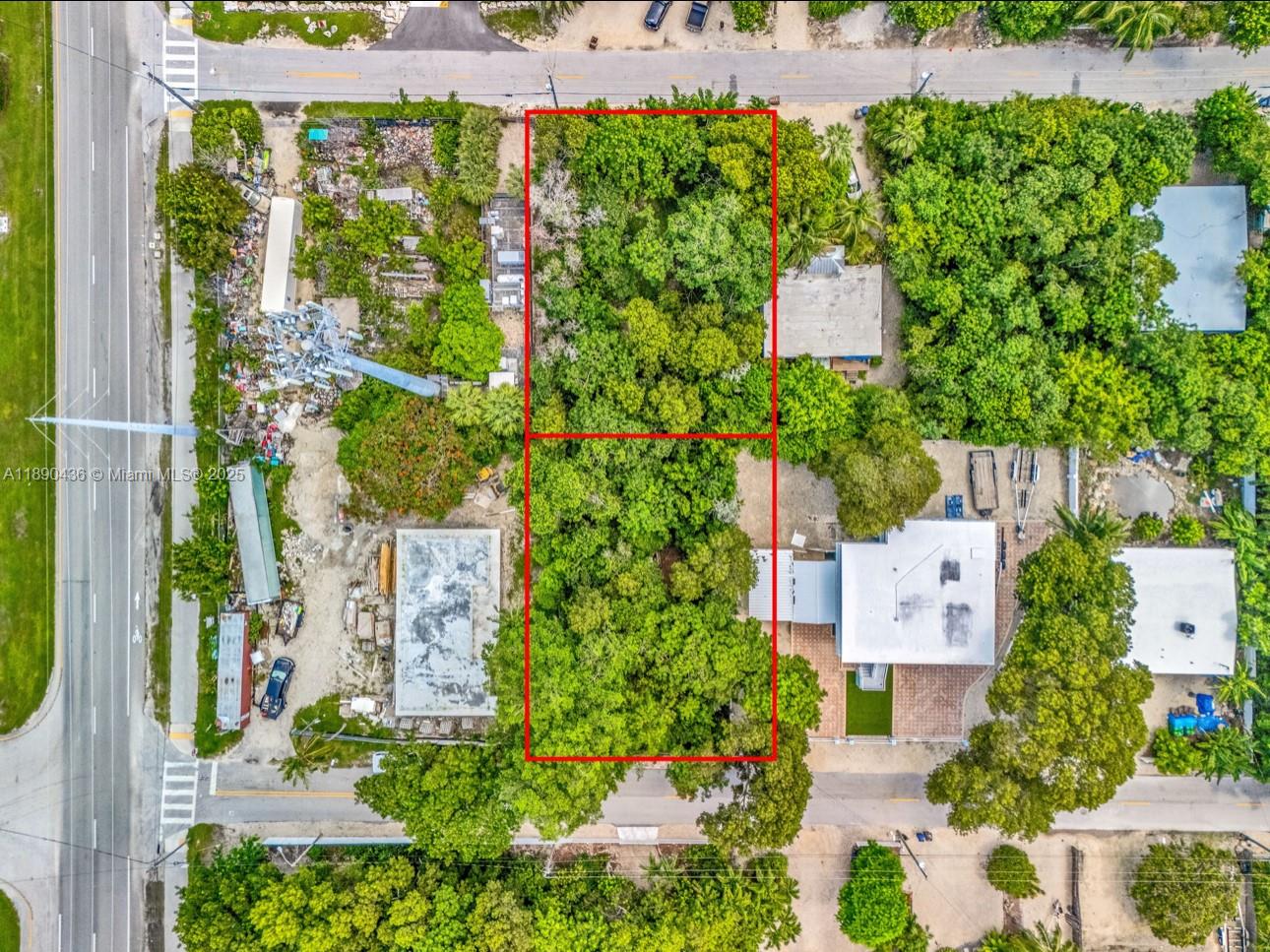 This aerial view shows two adjacent, tree-covered vacant lots outlined in red — 1032 Snapper Ln, Key Largo FL 33037, KEY LARGO, FL