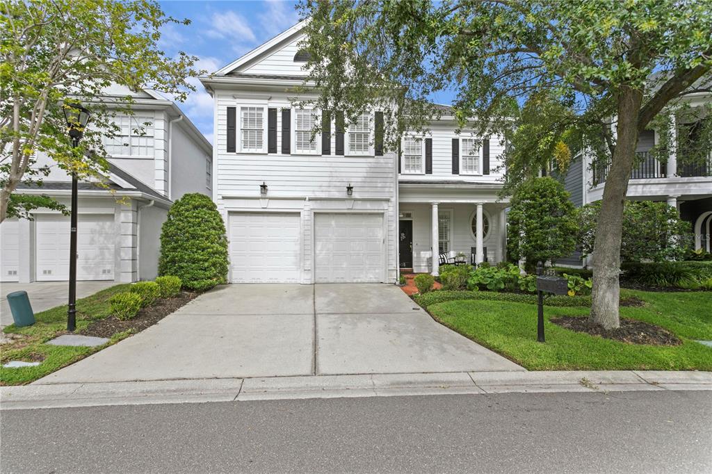 A two-story white house with a two-car garage and a front porch — 905 HARBOUR BAY DRIVE, TAMPA, FL