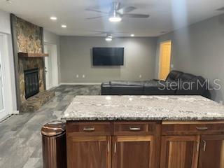 A living room features a stone fireplace, brown sectional sofa, and tile flooring — 2901 BEAGLE PLACE, SEFFNER, FL