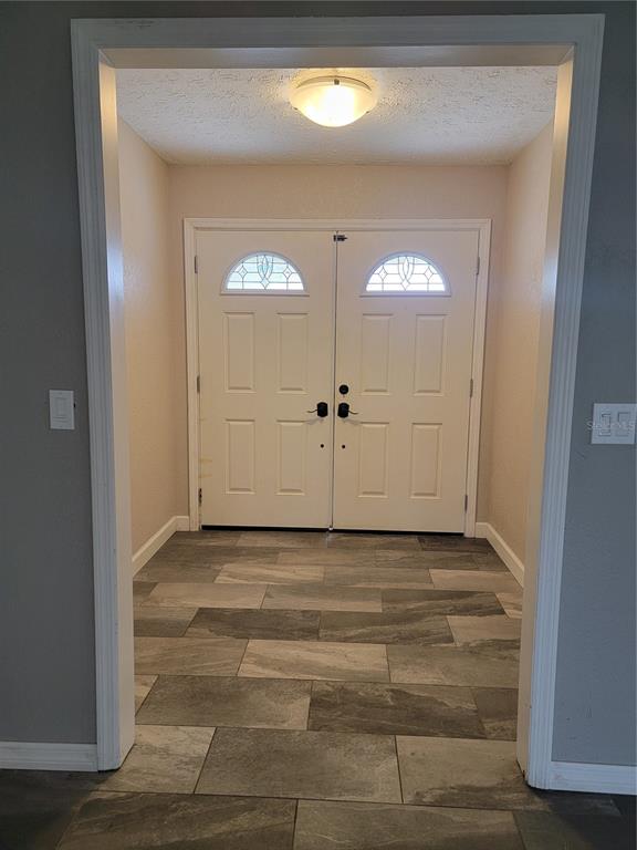 An open-concept living room features a brown sectional sofa, a coffee table, and wood cabinets — 2901 BEAGLE PLACE, SEFFNER, FL