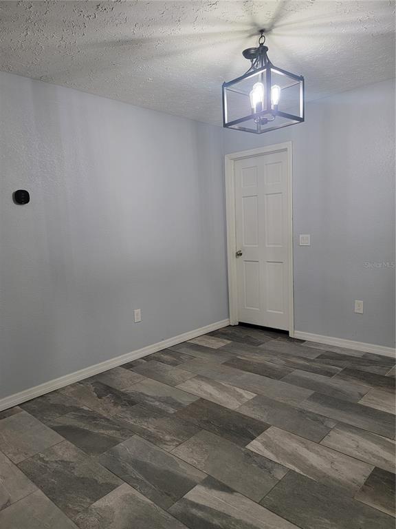 A living room features a brown sectional sofa, a television, and a patterned area rug — 2901 BEAGLE PLACE, SEFFNER, FL