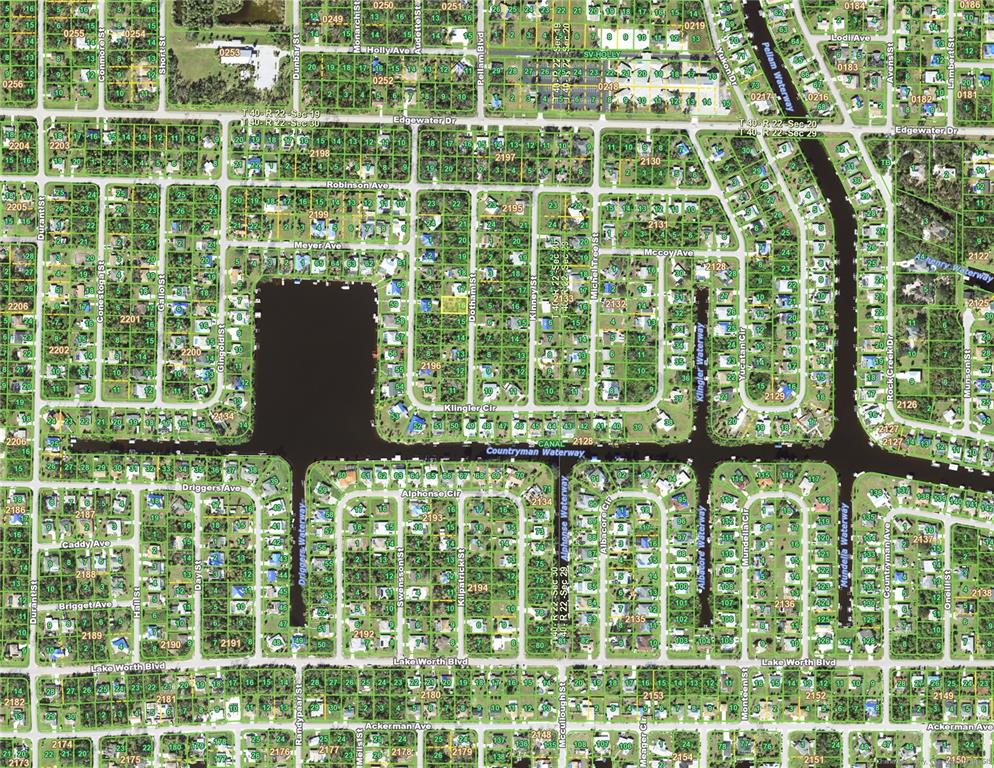 This is an aerial map showing a residential neighborhood with canals and numerous land parcels — 4091 DOTHAM STREET, PORT CHARLOTTE, FL