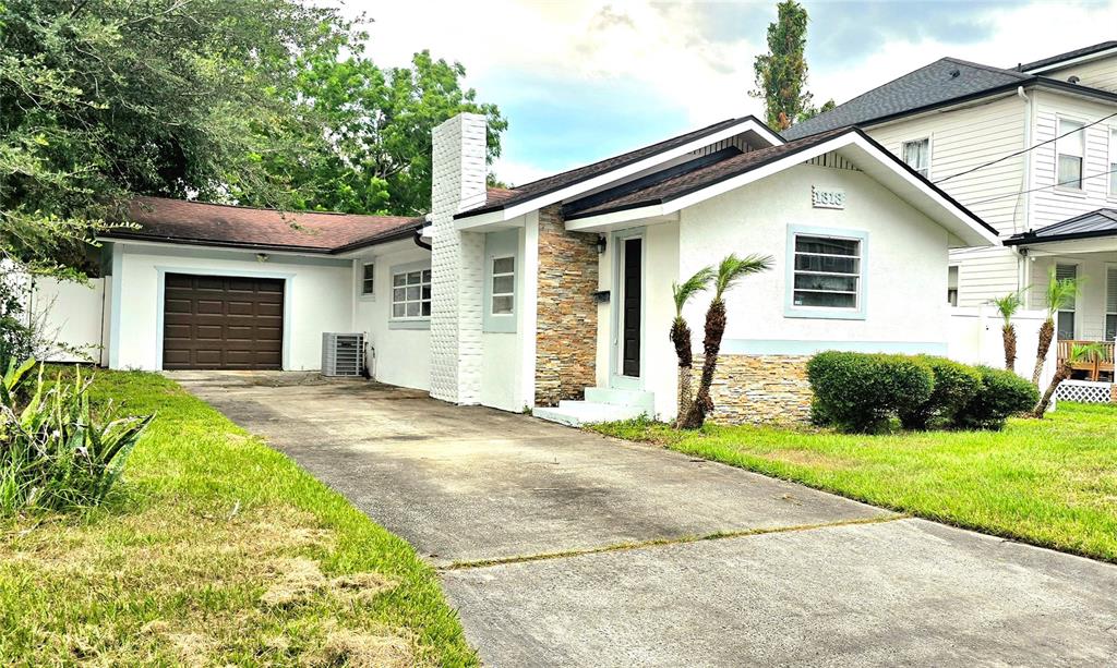 A white house with a stone-veneer base and a white vinyl fence in the yard — 1313 CATHERINE STREET, ORLANDO, FL