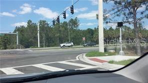 A view from inside a vehicle looking at a road intersection with traffic lights — INTERNATIONAL DRIVE, ORLANDO, FL