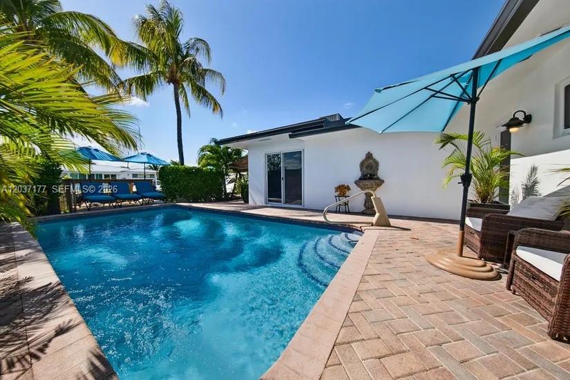 An aerial view shows a house with a metal roof, a swimming pool, and a boat — 2125 NE 17th Ter, Wilton Manors FL 33305, WILTON MANORS, FL