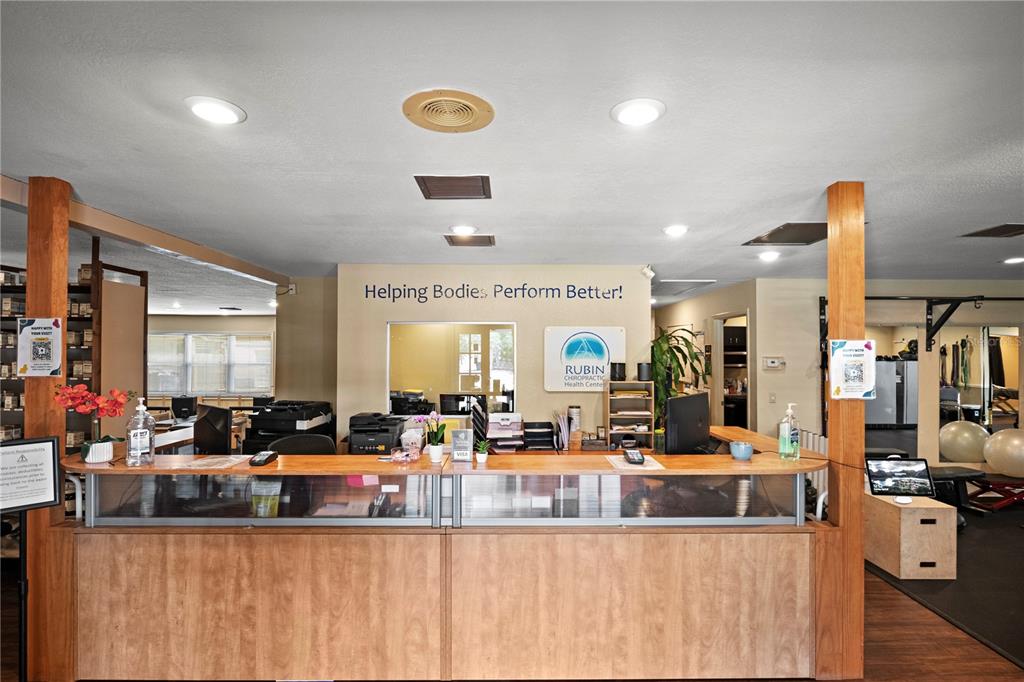 A chiropractic office reception area features a long wooden desk and a gym space — 1700 DR MARTIN LUTHER KING JR STREET N UNIT A, ST PETERSBURG, FL