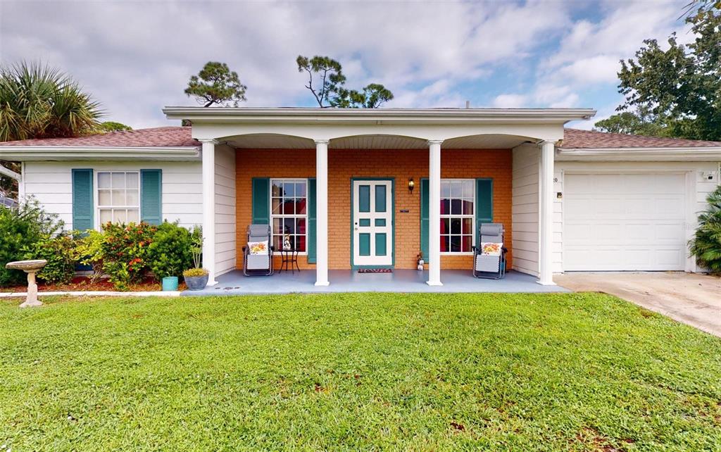 A single-story house with a brick facade, white columns, a front porch, and a garage — 2320 ALTON ROAD, PORT CHARLOTTE, FL