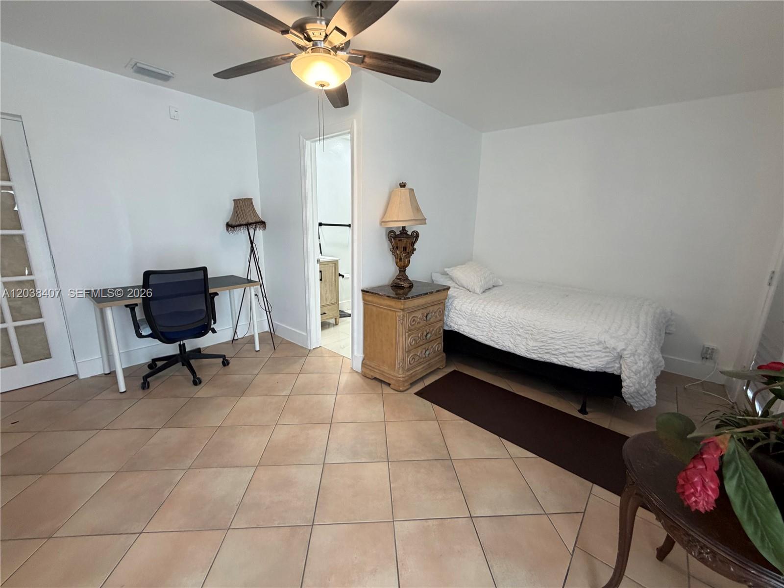 A bedroom features a single bed, a desk with a chair, and an attached bathroom — 5931 SW 148th Pl # 1, Miami FL 33193, MIAMI, FL