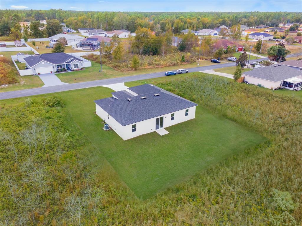 An aerial view shows a single-story house with a dark roof on a grassy lot — 17191 SW 40TH TERRACE, OCALA, FL