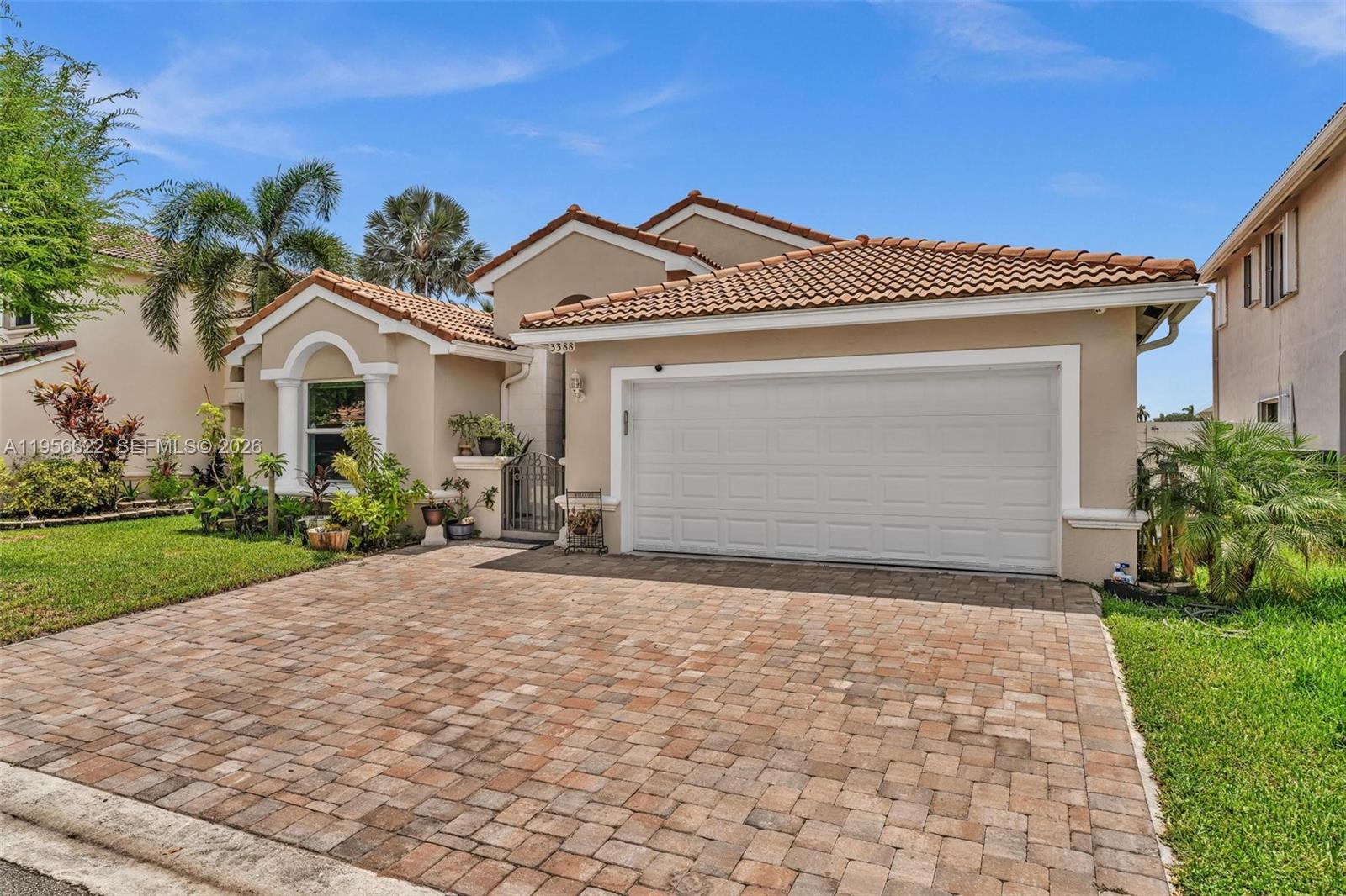 A single-story house with a tiled roof, a two-car garage, and a paved driveway — 3388 SW 49th St, Hollywood FL 33312, HOLLYWOOD, FL