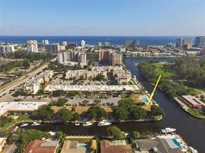 An aerial view shows a waterfront apartment complex with a pool and docked boats — 1323 NE 28th Avenue # 126, Pompano Beach FL 33062, POMPANO BEACH, FL