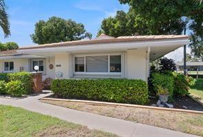 A single-story house with a beige exterior, a wide front window, and a manicured hedge — 1323 NE 28th Avenue # 126, Pompano Beach FL 33062, POMPANO BEACH, FL