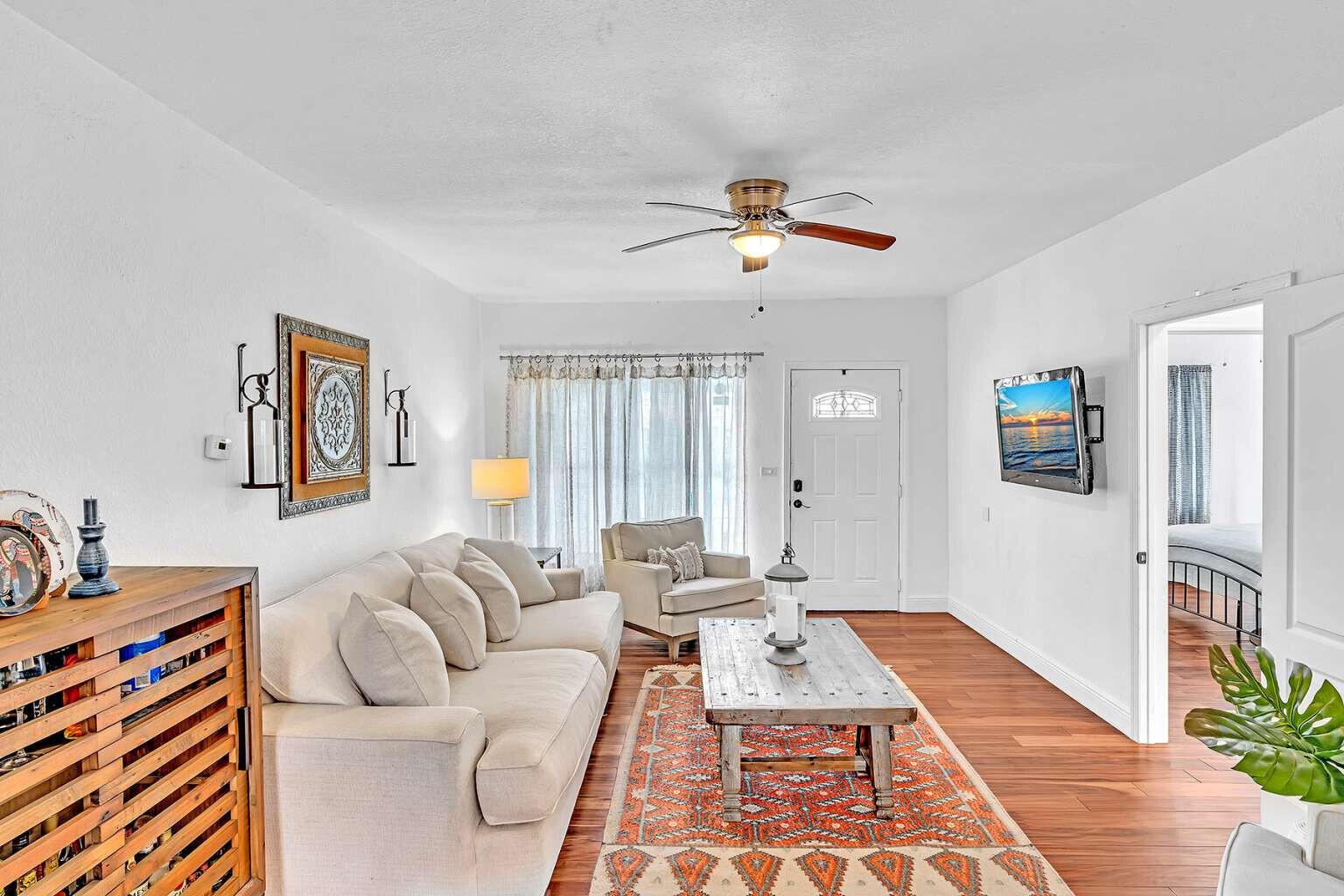 A living room features a beige sofa, wooden coffee table, area rug, and ceiling fan — 784 NE 81st Street, Miami FL 33138, MIAMI, FL