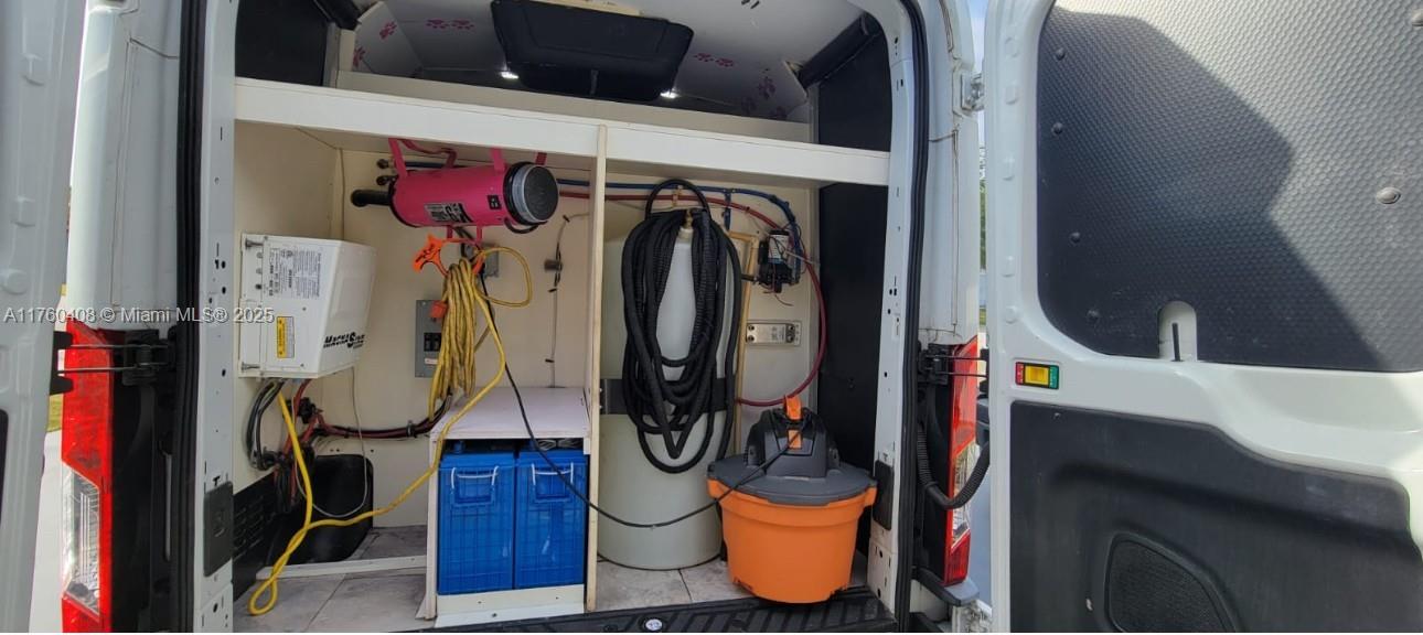 The rear of a work van is equipped with shelving, a water tank, and equipment — TBD, Miami FL 33175, MIAMI, FL