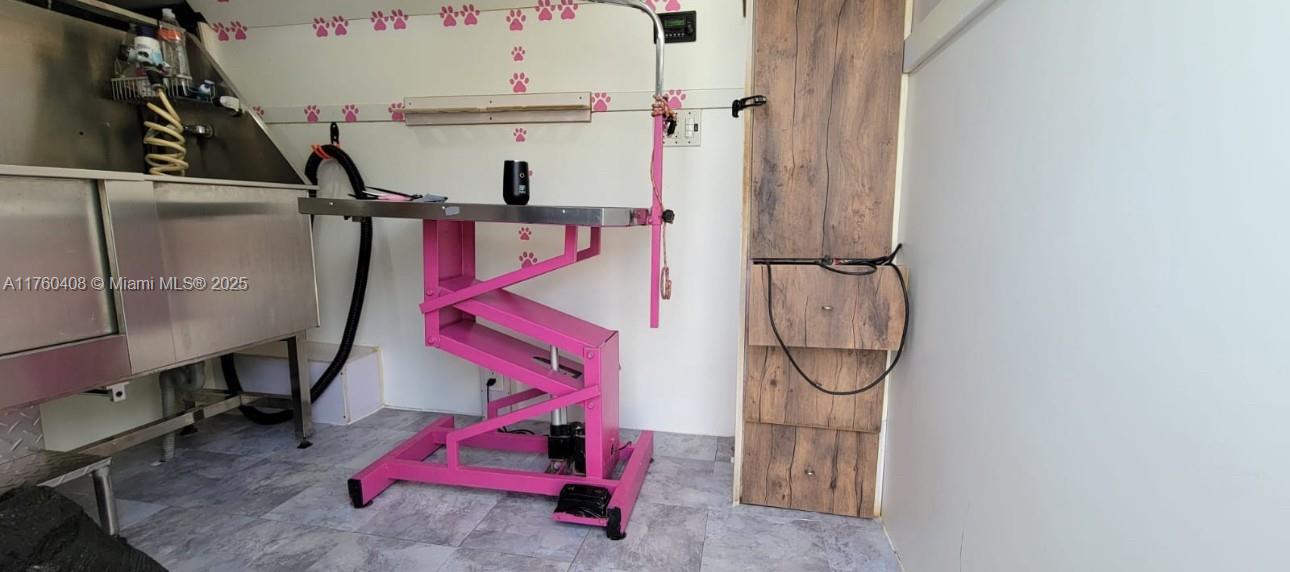 This mobile pet grooming station features a stainless steel tub and a pink hydraulic table — TBD, Miami FL 33175, MIAMI, FL
